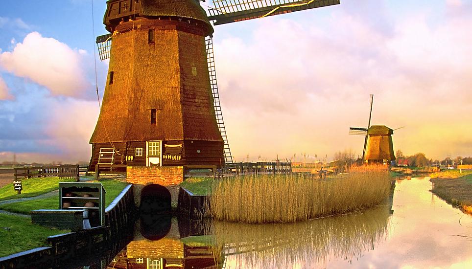 Traditional Dutch windmills along a canal