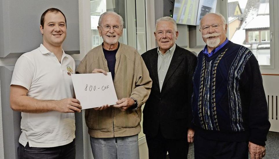 Fabian Stettler von «Pizza-Crew» überreicht Herbert Aschwanden einen Scheck. Daneben: «Hilfe für Simbabwe»-Mitglieder Ernst Sauerbruch und Kurt Werner (v. l.) Bild: Selwyn Hoffmann