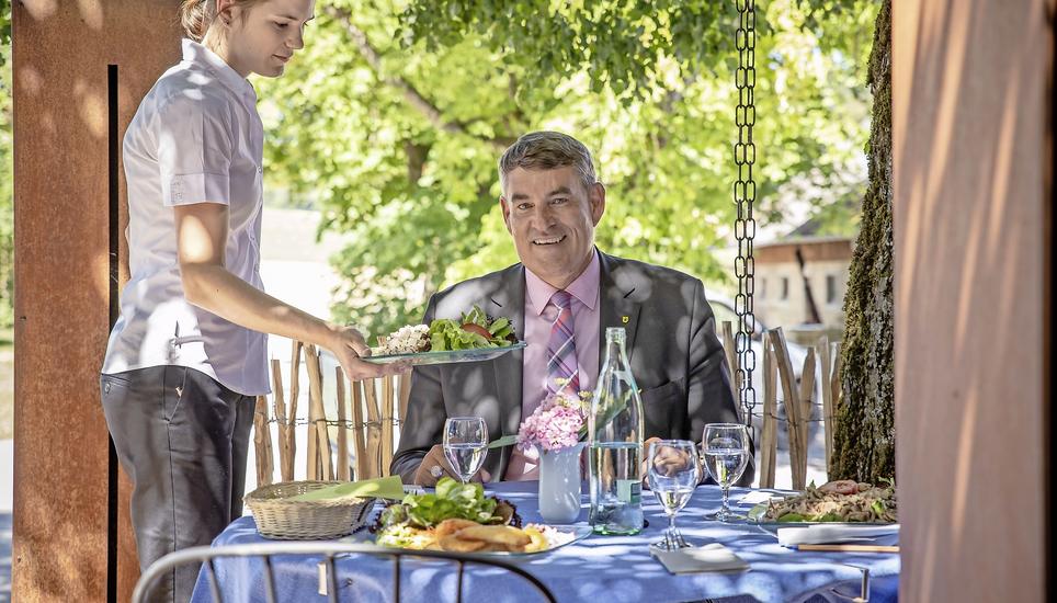 Im Garten der Gastwirtschaft zum Gennersbrunnerhof bekommt Christian Amsler einen garnierten Wurst-Käse-Salat serviert. Bild: Roberta Fele