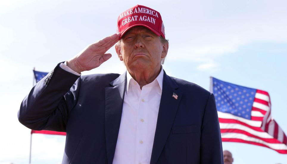 FILE - Republican presidential candidate former President Donald Trump salutes at a campaign rally March 16, 2024, in Vandalia, Ohio. Trump is making the Jan. 6, 2021 attack on the Capitol a cornerstone of his bid to return to the White House. Trump opene