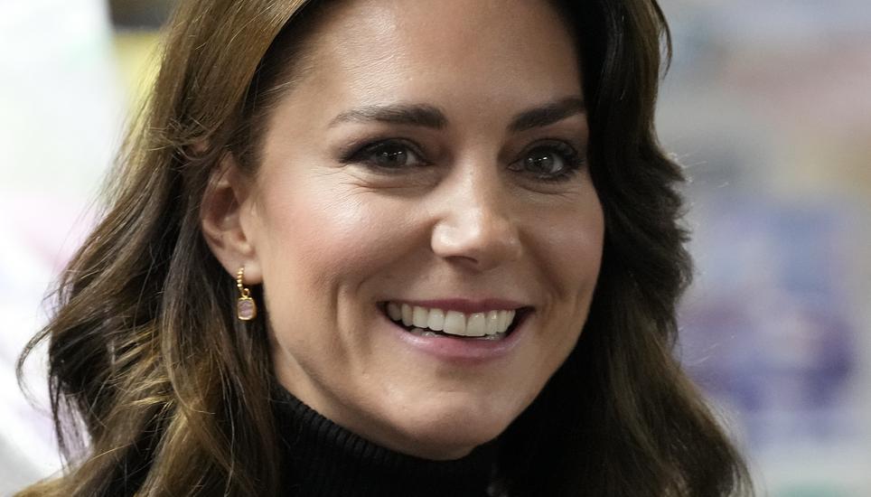 FILE - Kate, Princess of Wales smiles as she speaks to a woman during her visit to Sebby's Corner in north London on Nov. 24, 2023. Charles' illness comes at a awkward time, as his daughter in law, the Princess of Wales, has also had her own health issues