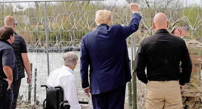 Republican presidential candidate former President Donald Trump gestures to people across the Rio Grande in Mexico at Shelby Park during a visit to the U.S.-Mexico border, Thursday, Feb. 29, 2024, in Eagle Pass, Texas. (AP Photo/Eric Gay)