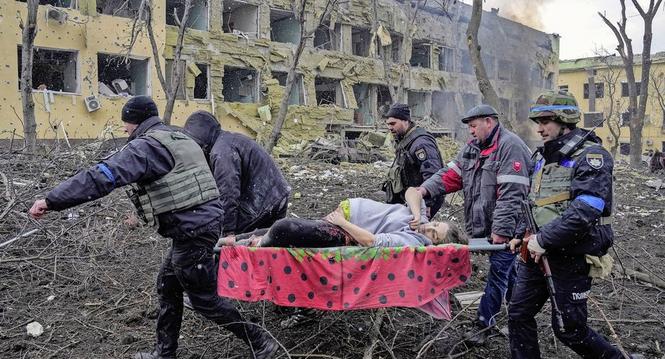 FILE- Iryna Kalinina, 32, an injured pregnant woman, is carried from a maternity hospital that was damaged during a Russian airstrike in Mariupol, Ukraine, on 9 March 2022. Associated Press photographer Evgeniy Maloletka won the World Press Photo of the Y
